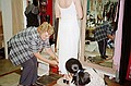 Mum helping Margaret having fitting for wedding dress